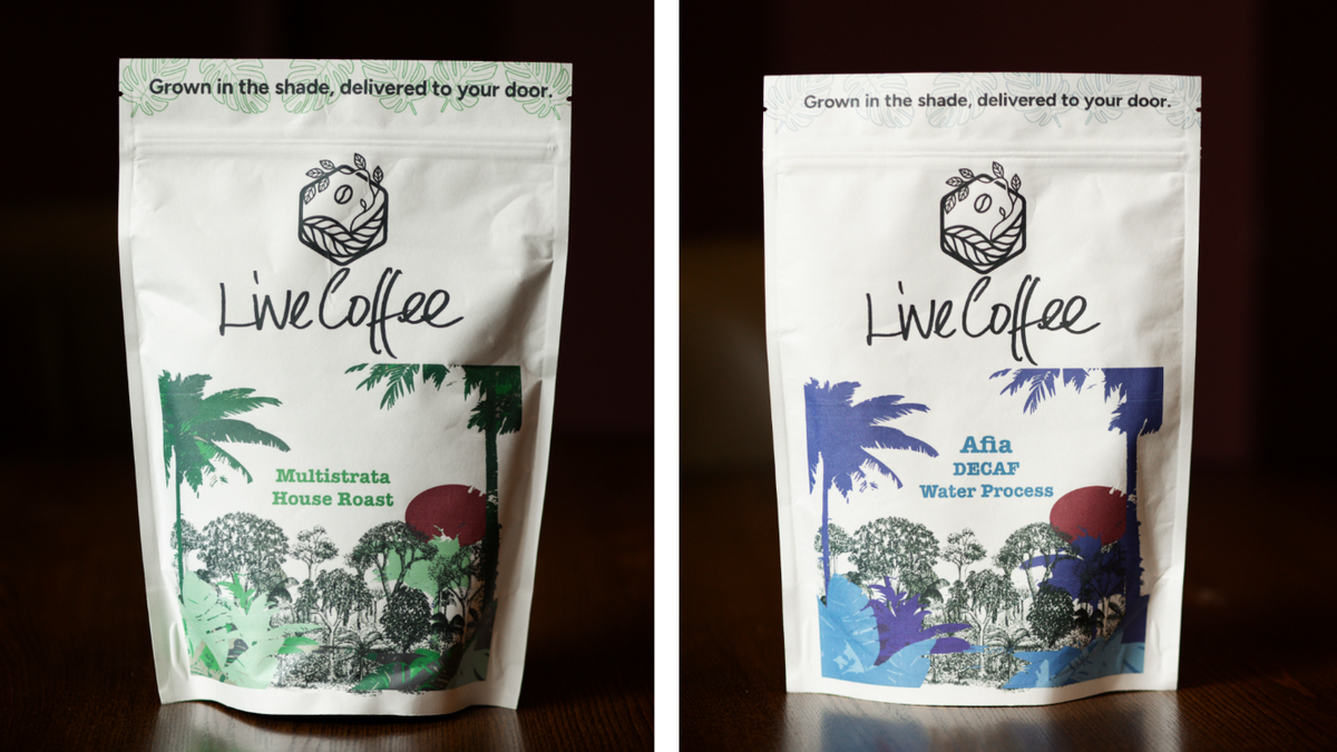 Two packages of Live Coffee on a dark background